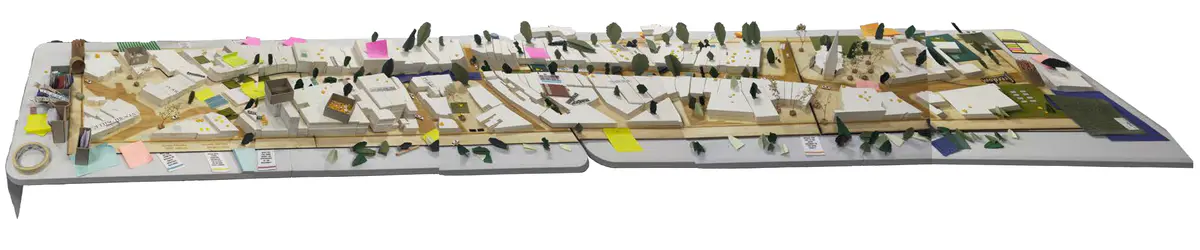 Looking to be the centrepiece of our exhibition, we proposed to create a site model of Dudley Highstreet at 1:200 scale with buildings modelled in a simple form. Local residents and visitors to the exhibition are then invited to decorate a chosen building to how they would envision it sat within the context of a greener Highstreet. We want to tie in our themes of biodiversity and materials by proposing that buildings can, and do, have the potential to be a lot healthier, sustainable, and interactive on the street. This site model also helps gain vital public opinions on the Highstreet and prompts discussion of areas most in need of attention.

To ensure that the model is utilising the MDF to the most efficient standard possible. First, the centres of the massing blocks have been hollowed out. This allows a reduction in materials used as other buildings can be cut in the centres of the model. Then the top is finished with a solid piece.
The waste material is placed into the recycling rack where other students can reuse it; otherwise, if the material left cannot be used for another project, it is recycled correctly by the university.

The model spanned just over 3.4m long and over 50cm wide. With the majority being cut from scrap woods that would fit the jigsaw of the shape, we were able to drastically cut down on waste. We also got some small benches and bee hives printed from recycled plastics, and used dried flowers as trees to represent the green spaces. Ultimately, the model seemed like a huge success, and really helped portray our ideas about Dudley High Street to those who came by. Everyone from Dudley who saw the model knew that it was the High Street, and interacted well with it. The size did make it difficult to move, especially to carry to the site, but it sat nicely in the centre of the the room and really drew people in to interact with it.

The model brought people in from outside to play with, write on, interact with. It became a spectacle for the public to come in and see what was happening and offer their ideas about what could be done.

The event was a success. Many people from the public (those who heard about the event, and those who just happened across it on the day) came in to interact with the model, which sat as the centre piece in the room. Kids liked to play with the pieces while the adults talked about things that could come from actions to help the High Street, not just leave it as is.

SOME OF THE KEY IDEAS WERE:
- The Shops need to be inviting for everyone. It’s no good having these places to go if people would rather take a bus to the next town.
- Just putting up boards across the windows is awful. Paint, Posters, Graffiti: Anything that actually makes the High Street look still alive is better than just wooden boards.
- More Green is needed. While it is obvious that there is a lack of Trees, many people wanted to push for these small bushes or planting spaces that could easily be implemented across the street.
- Spaces for public events or for people to at least gather at. While there is the Market and Fountain, it is not enough for the people of Dudley.
- Something needs to be done about the cars on the High Street. Some were Pro-Removal of all Cars, while some just wanted to limit when they could access the High Street.

Following the exhibition we created a series of drawings with our own interpretation of Sarah Wigglesworth ‘The Dining Table’ drawing. The drawings are a perfect representation of the our interactive model at the ERA Environmental Exhibition and Event. Showing the interaction the public had with the model, as well as the conversations that were held around the model. - Model - final.png